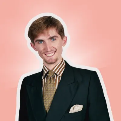 profile picture of a young guy wearing a suit on a coral background