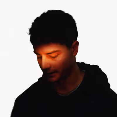 a profile picture of a guy with a red orangey light stroking his face on a white background