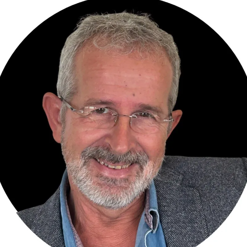 profile picture of an elder man wearing a suit and looking directly at the camera