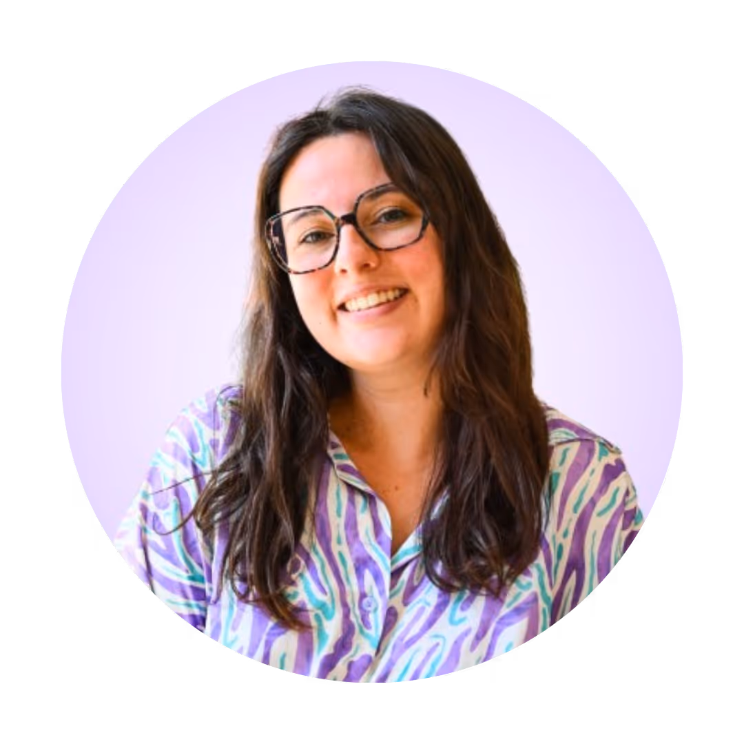 a profile picture of a young girl with bangs and glasses on a light purple background 